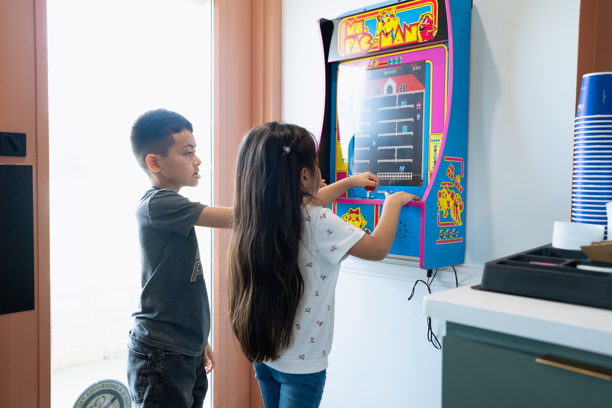 Kids playing arcade in our lobby